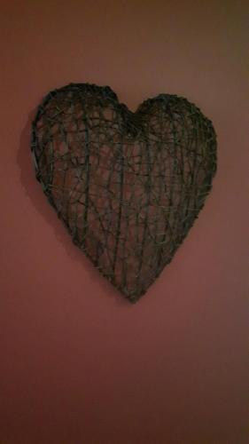 a heart hanging on a wall at Gîte Au Coeur de Champlon in Champlon