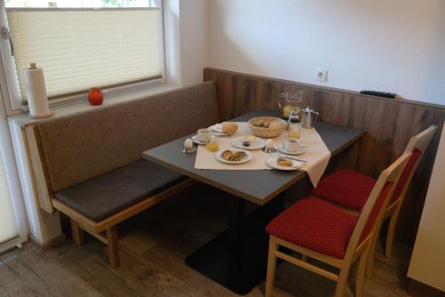 a table with plates of food on top of it at Apart Felsenhof in Längenfeld