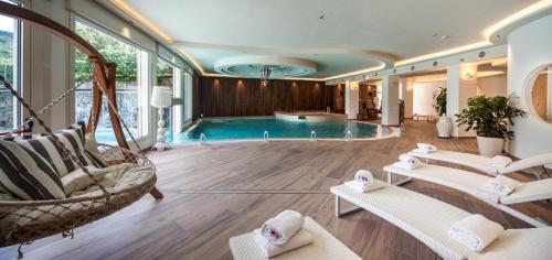 a large room with a swimming pool and chairs at Hotel Miramonti in Bagno di Romagna
