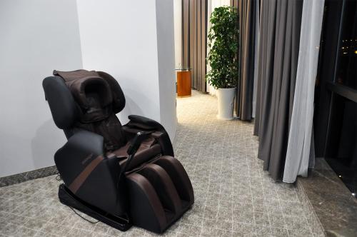 a black chair sitting on the floor in a room at Parliament Palace Hotel in Khujand