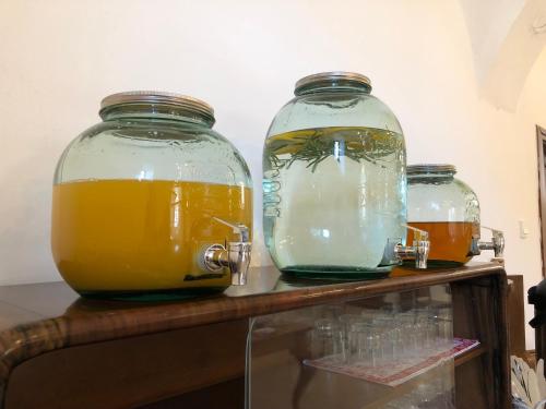 two glass jars of orange juice on a shelf at The Houses of History - anno 1830 in Tihany