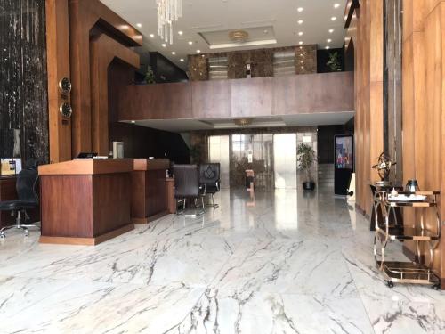 a lobby of a hotel with a marble floor at Golden Bujari AlUlaya Hotel in Al Khobar