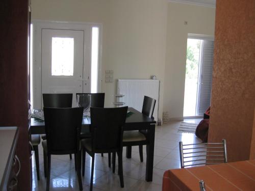 a dining room with a black table and chairs at Chara host in Olympia