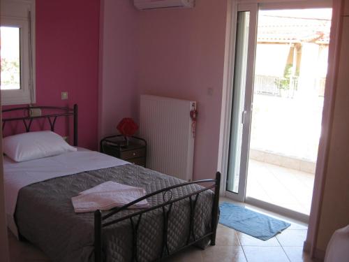 a bedroom with a bed and a large sliding glass door at Chara host in Olympia
