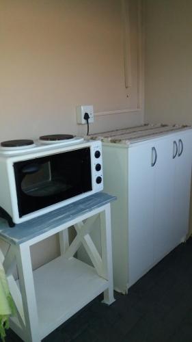 a microwave sitting on a table in a kitchen at Sunflower Self-Catering in Walvis Bay