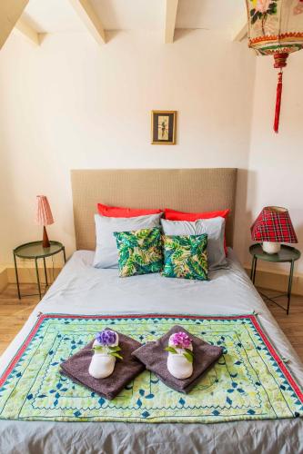 a bedroom with a bed with two towels on it at The Livingrooms Laren in Laren