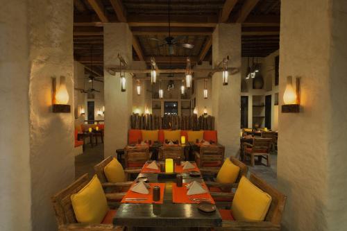 a dining room with a table and chairs in it at Six Senses Zighy Bay in Dibba