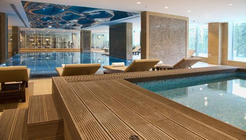 a pool in a hotel with chairs and a swimming pool at Rotta Hotel Istanbul in Istanbul