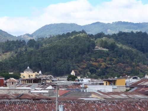a view of a town with mountains in the background at Posada San Vicente by AHS in Antigua Guatemala