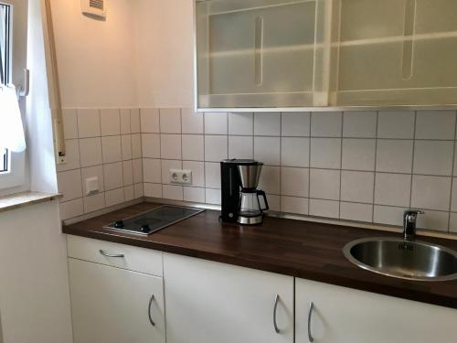 a kitchen with a sink and a counter top at Bed & Kitchen in Gießen