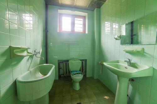 a bathroom with a sink and a toilet and a bath tub at Eco House Sabero in Akhmety