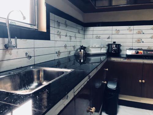a kitchen with a sink and a counter top at Luzville Residences -C9 in Naic
