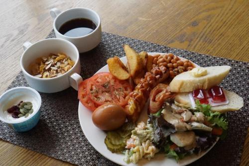 a plate of food with a sandwich and a cup of coffee at I-Jin Hotel in Jeju