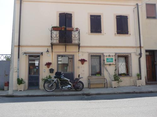 a motorcycle parked in front of a building at B&B Tredomus in Tresnuraghes