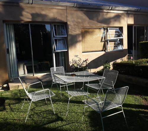 a group of chairs and a table in a yard at 35 on Basil in Caledon