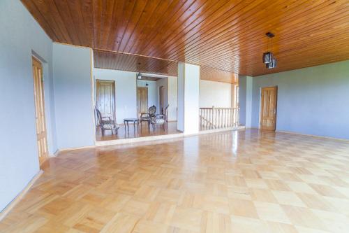 an empty room with a wooden ceiling and a wooden floor at Eco House Sabero in Akhmety