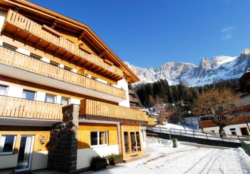 a building with a view of the mountains at Residence Adler in San Martino di Castrozza