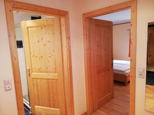 a pair of doors in a room with a bedroom at Gasthof Kirchenwirt in Lackenhof