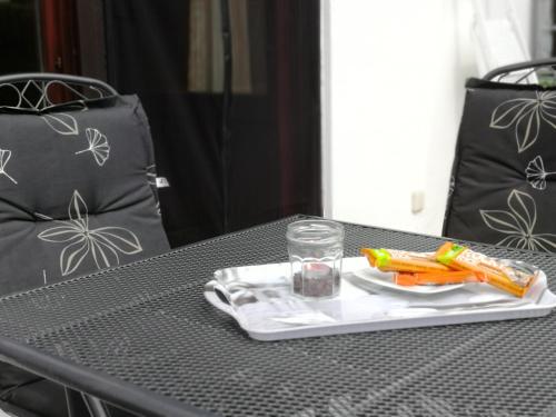 a tray of carrots and a glass of water on a table at Eifel Ferienhaus Luna in Ohlenhard