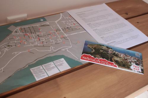 a map and a book on a table at lovely studio with awesome view in Tolo