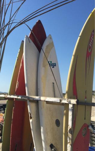 a group of surfboards lined up in a rack at Leucate in Leucate