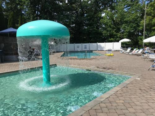 a water fountain in the middle of a pool at Two bedroom mountain condo, 2 minutes from ski resort, pool and clubhouse onsite ! in Gatlinburg