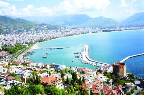 a view of a city with a harbor and the ocean at Twin Apart Hotel in Alanya