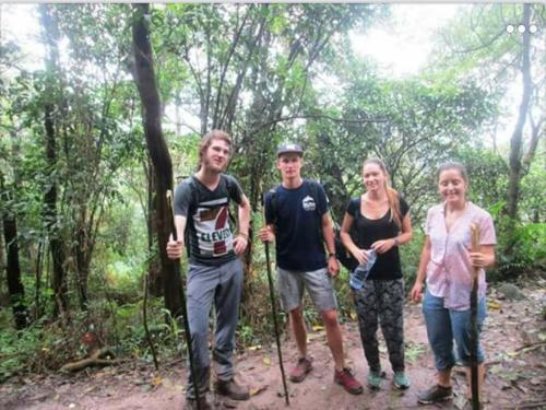 a group of people standing on a trail in the woods at De Salak Homestay in Bogor