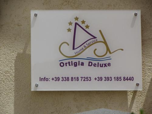 a sign for the office of otolia deluxe at Ortigia Deluxe S.A.L. in Syracuse