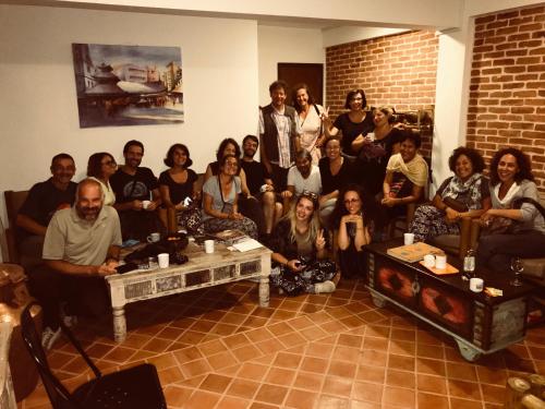 a group of people posing for a picture in a room at Hotel Timila in Pātan