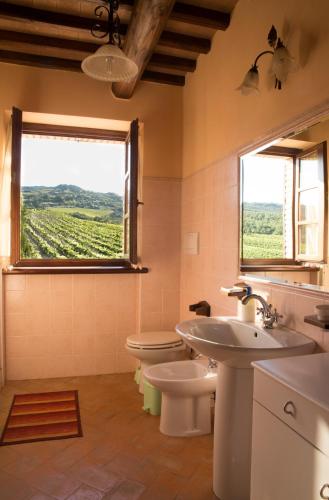 a bathroom with a sink and a toilet and a window at Villa Podere S.Antonio in Orvieto