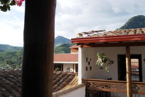 a view of a house with mountains in the background at Sergeant Pepper's Hostel in Jardin