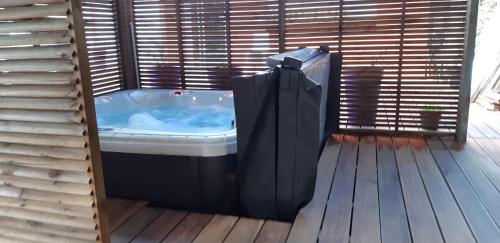 a bath tub sitting on a wooden deck at Domaine Choco Vanille in Deshaies