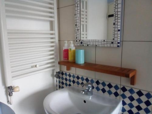 a bathroom with a sink and a mirror at Chambre Saint-Sauveur in Les Andelys