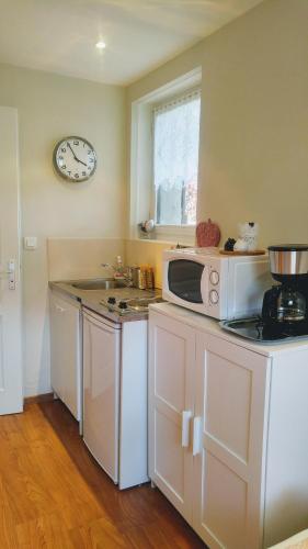 a kitchen with a microwave and a counter top at Charmant studio á Autrans in Autrans