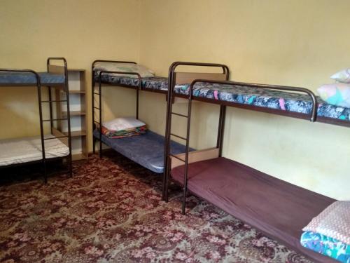 a group of bunk beds in a room at Schronisko Młodzieżowe Małgosia in Łazy
