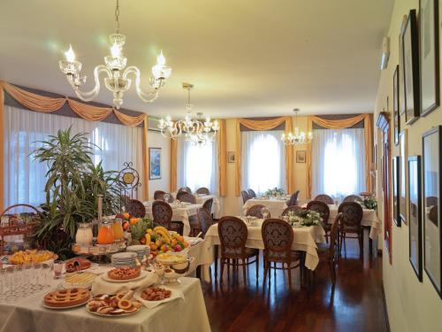 a dining room with a table with food on it at Locanda al Castello Wellness Resort in Cividale del Friuli