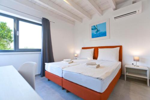 a bedroom with a bed and a large window at Wellness & Spa, Villa STELLA - heated pool, facilities for children, close to beaches and the sea, Medulin - Istria in Pomer