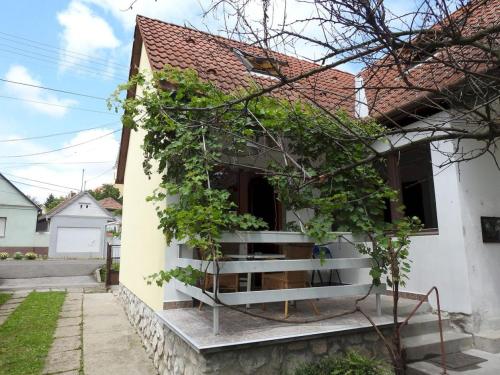a house with a staircase in front of it at Barackos Vendégház Bár in Bár