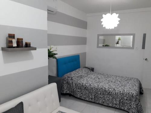a bedroom with a bed and a chandelier at Isla Verde Apt Two-Bedroom in San Juan