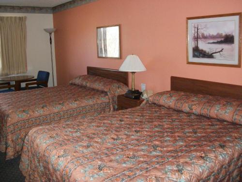 a hotel room with two beds and a table at Lodi Valley Suites in Lodi