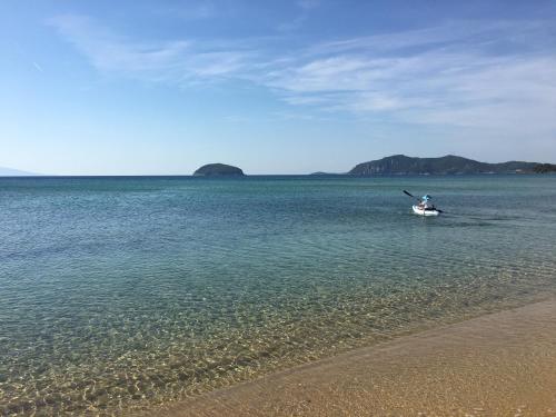 a person in a boat in a body of water at Hotel Akti Kavala in Paleo Tsifliki