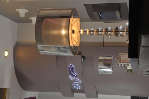 a kitchen with a sink and a tv on the wall at Comfort by Trio in Białystok