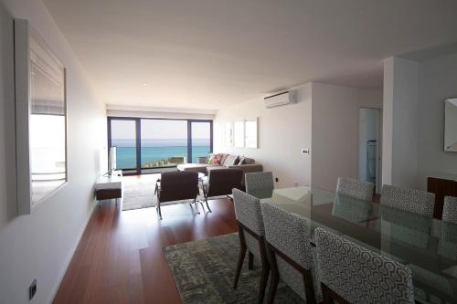a dining room and living room with a view of the ocean at Spacious luxury holiday apartment with a great view, Funchal, free wifi and parking in Funchal
