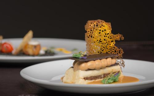 a white plate with a piece of food on a table at San Francisco Lodge in Los Andes