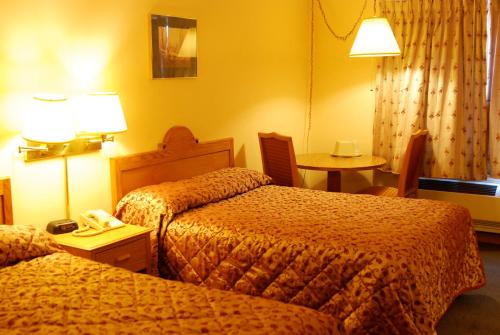 Katil atau katil-katil dalam bilik di Luck Country Inn