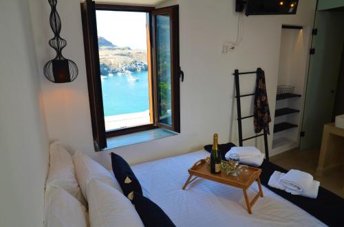 a living room with a white couch and a window at Lindos Aktaia Villa in Líndos