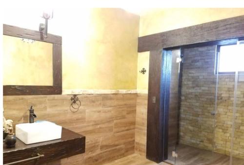 a bathroom with a sink and a mirror at Villa El Retiro Luxury Property in Alajuela City