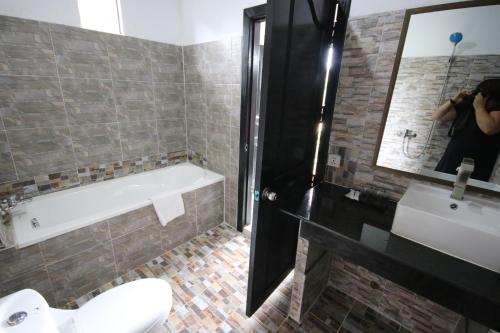 una persona che scatta una foto di un bagno di Green Life Cottage a Siem Reap
