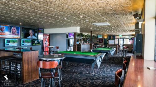 a bar with a pool table and billiard tables at Windsor Castle Hotel in East Maitland